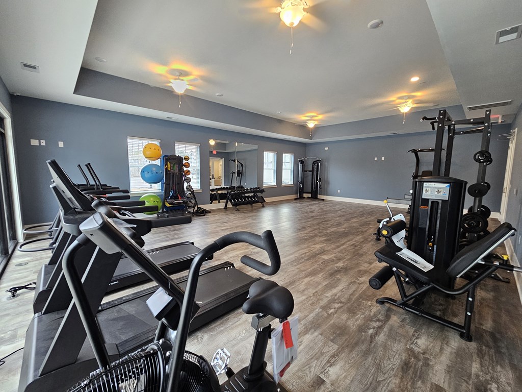 A spacious gym with treadmills, elliptical machines, and other exercise equipment.