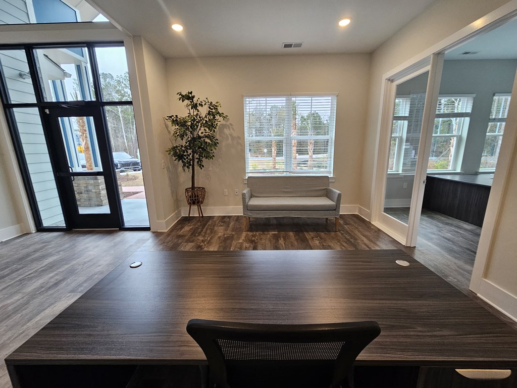 A room with a wooden table and a black chair.