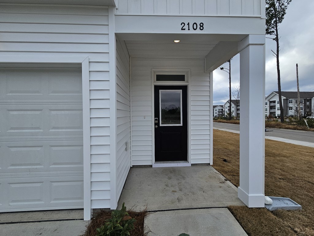 A white house with the number 2108 on the front.