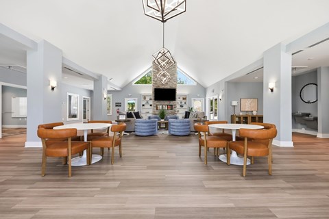 A modern dining room with a white table and chairs.
