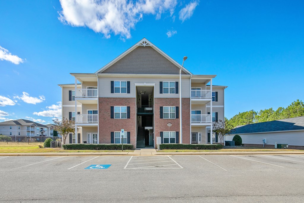 a large apartment building with a parking lot
