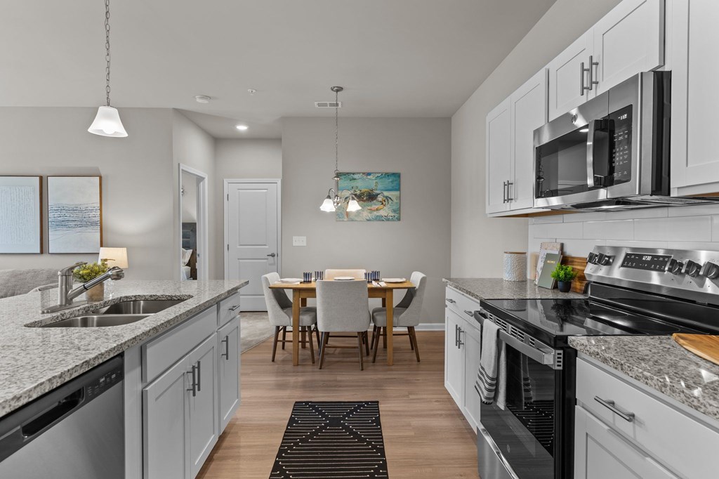 A modern kitchen with a dining table and chairs.