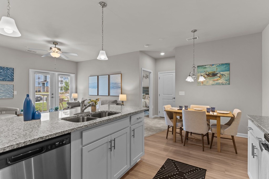 A modern kitchen with a dining table and chairs.