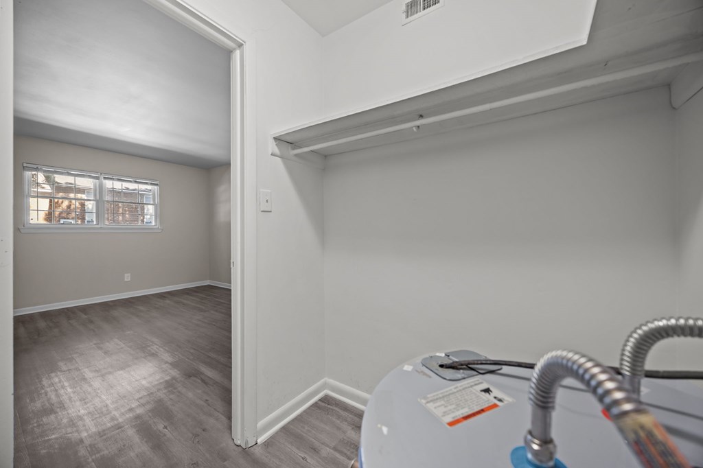 A room with a window and a wall-mounted air conditioner unit.