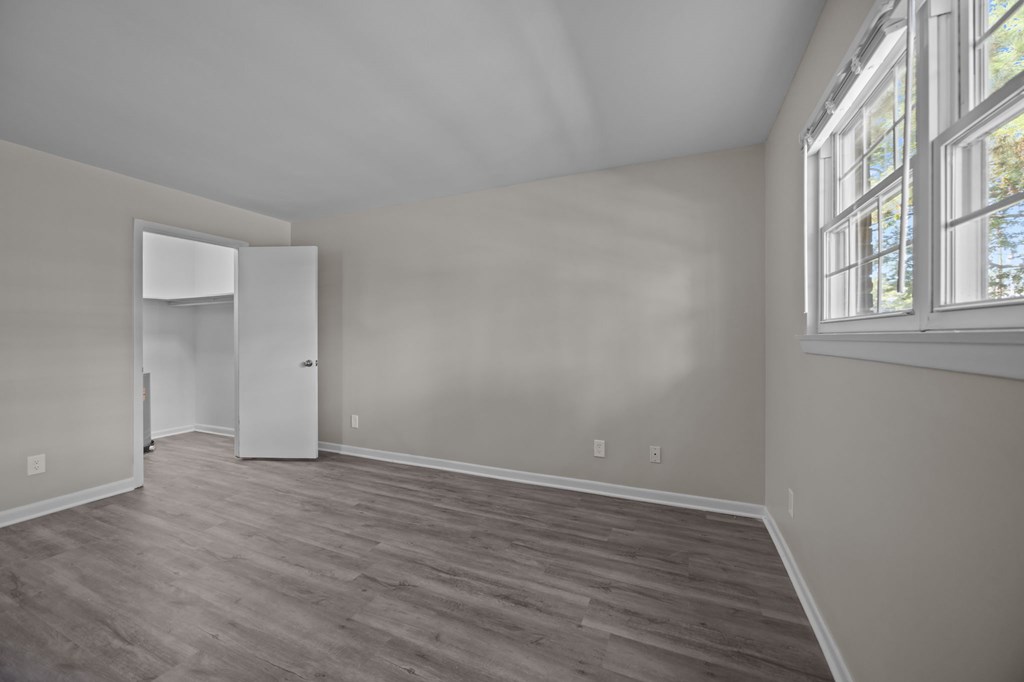 A room with a white door and a window.