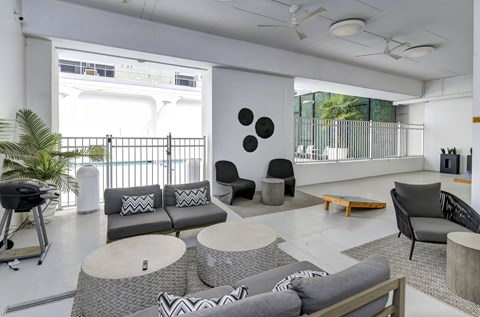A modern living room with a grey sofa and a coffee table.