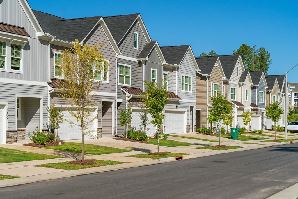 a row of houses on the side of a street
