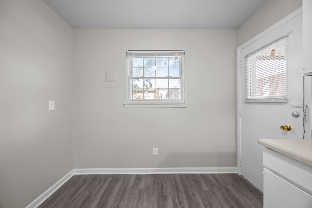 A room with a window and a door.