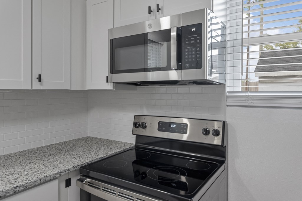a kitchen with a stove and a microwave