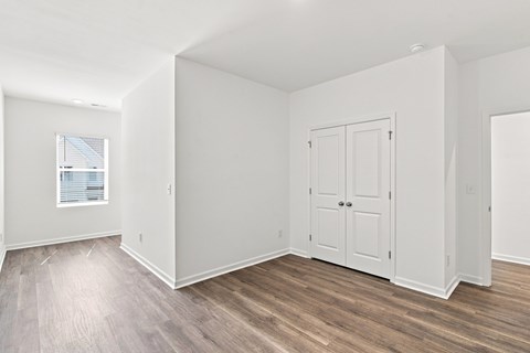 A room with a wooden floor and white walls.