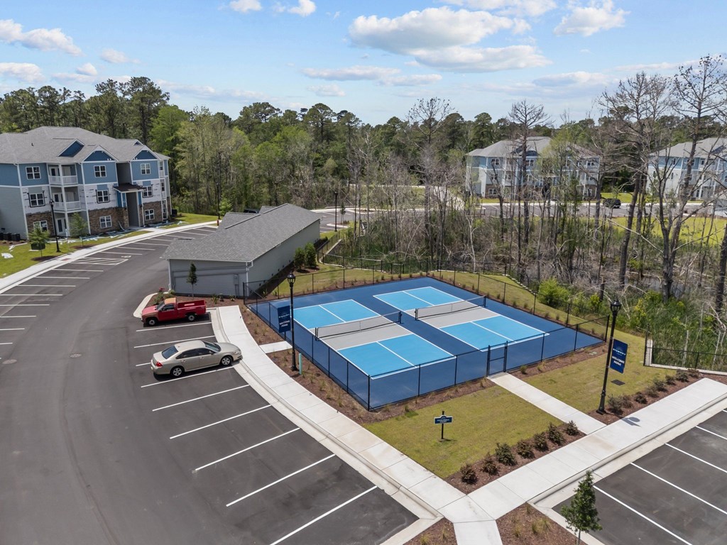 A large blue swimming pool surrounded by a parking lot.