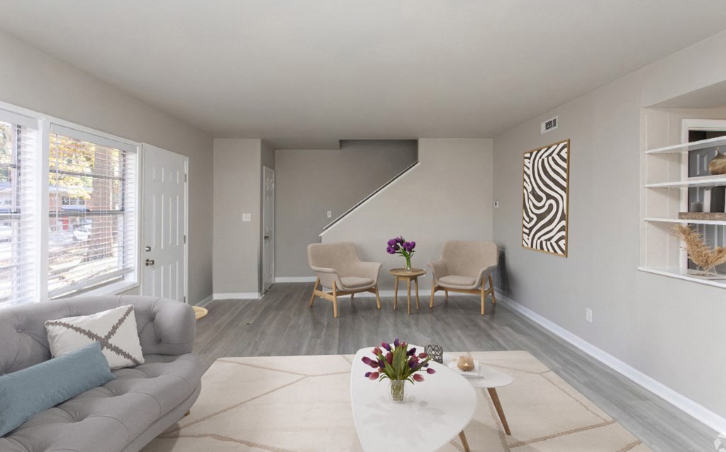 a living room with a couch and chairs and a table