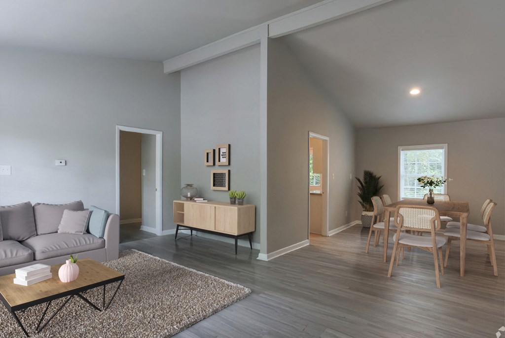 a living room and dining room with a table and chairs