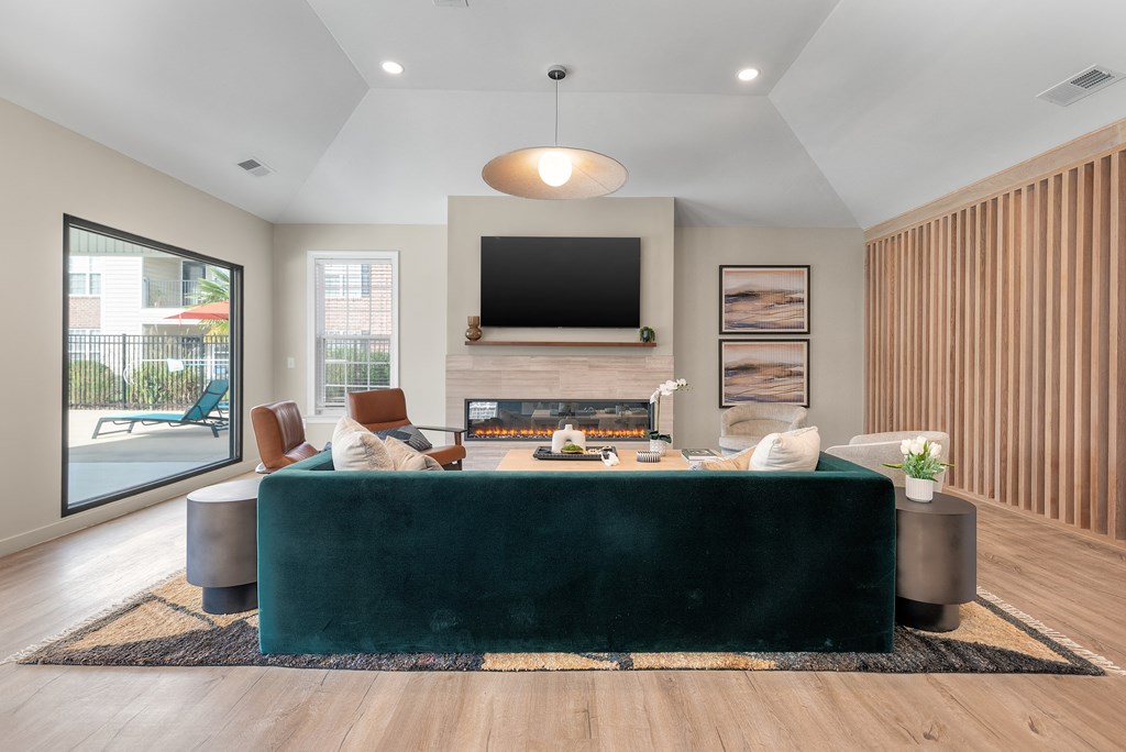 a living room with a green couch and a fireplace