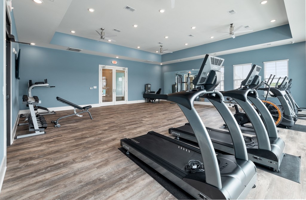 the gym at the enclave at woodbridge apartments in sugar land, tx