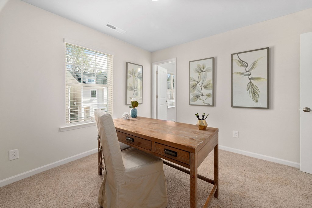 a home office with a wooden desk and a chair
