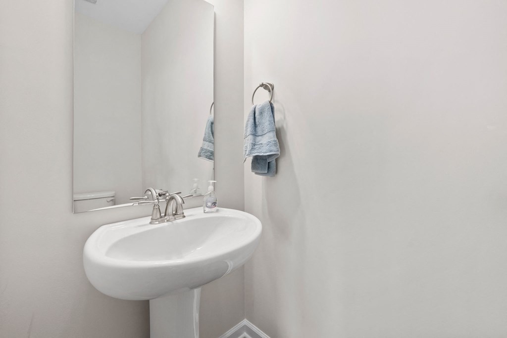 a bathroom with a sink and a mirror and a towel