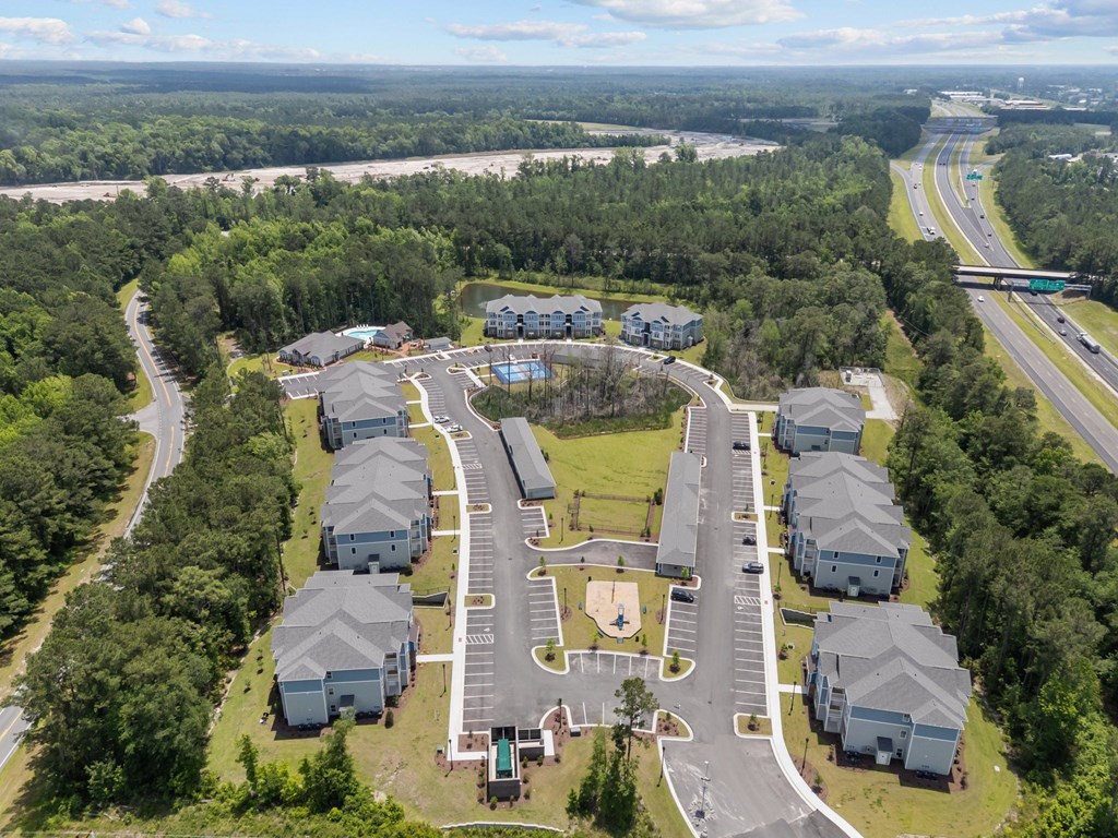 A bird's eye view of a residential complex with a playground in the center.