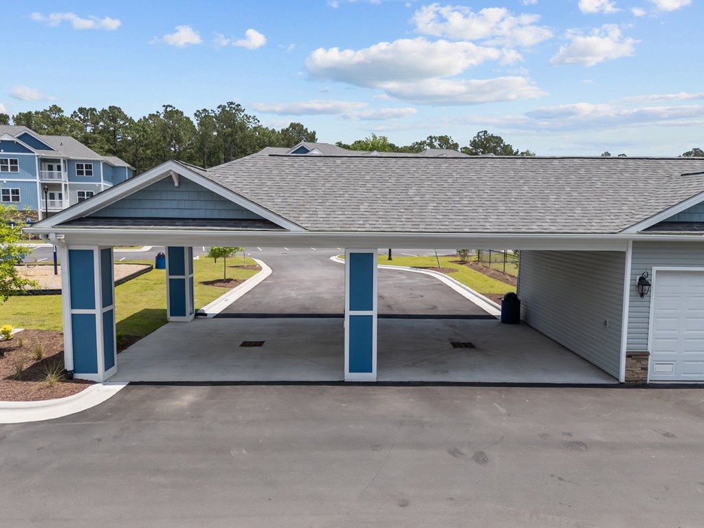 A covered parking area with a white garage door.