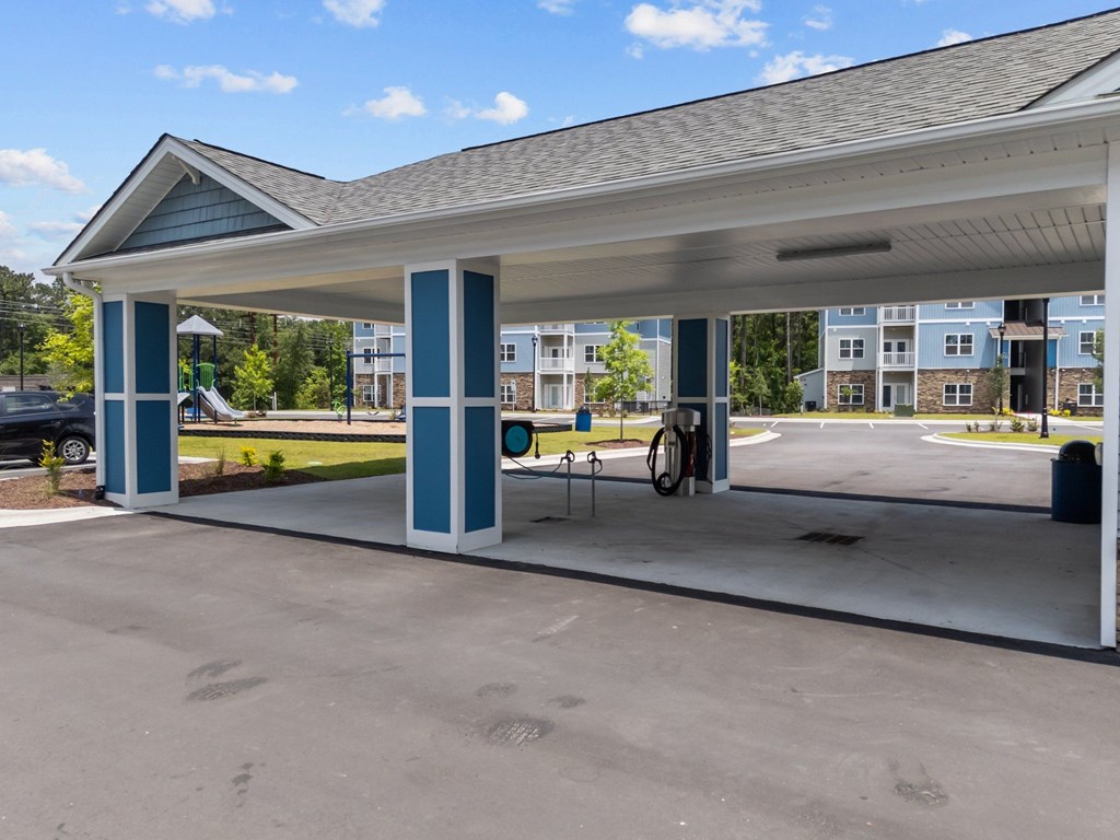 A gas station with a car parked in front.