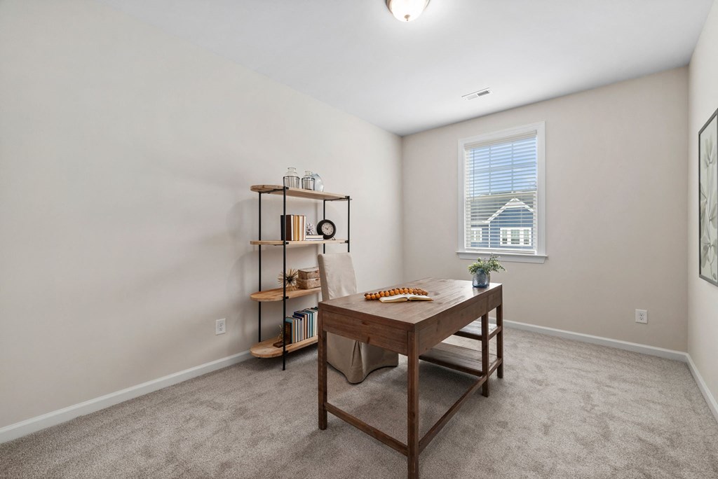 an empty room with a desk and a window