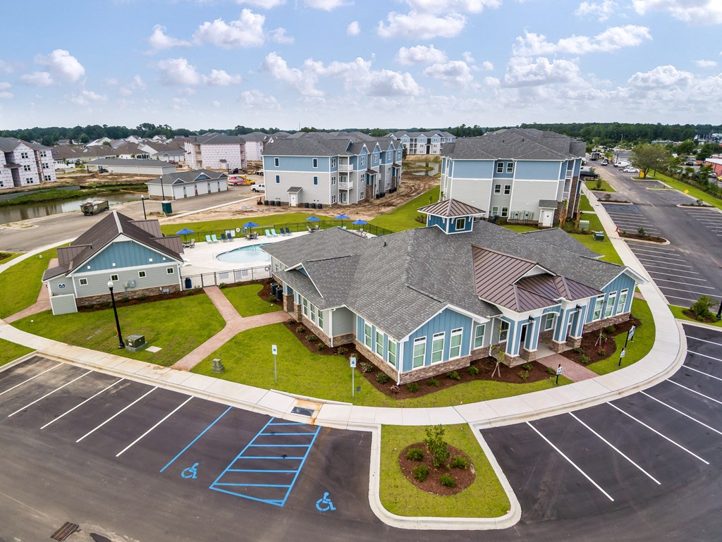an aerial view of a large home with a swimming pool in front of it