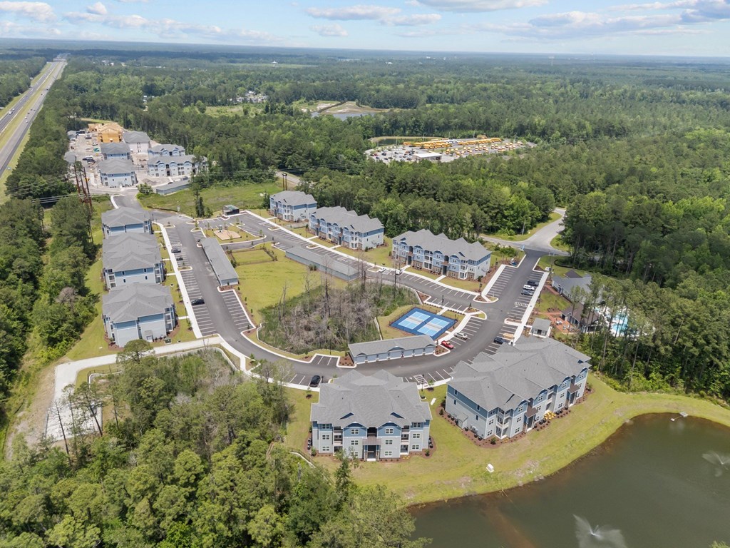 A bird's eye view of a residential area with houses and a swimming pool.