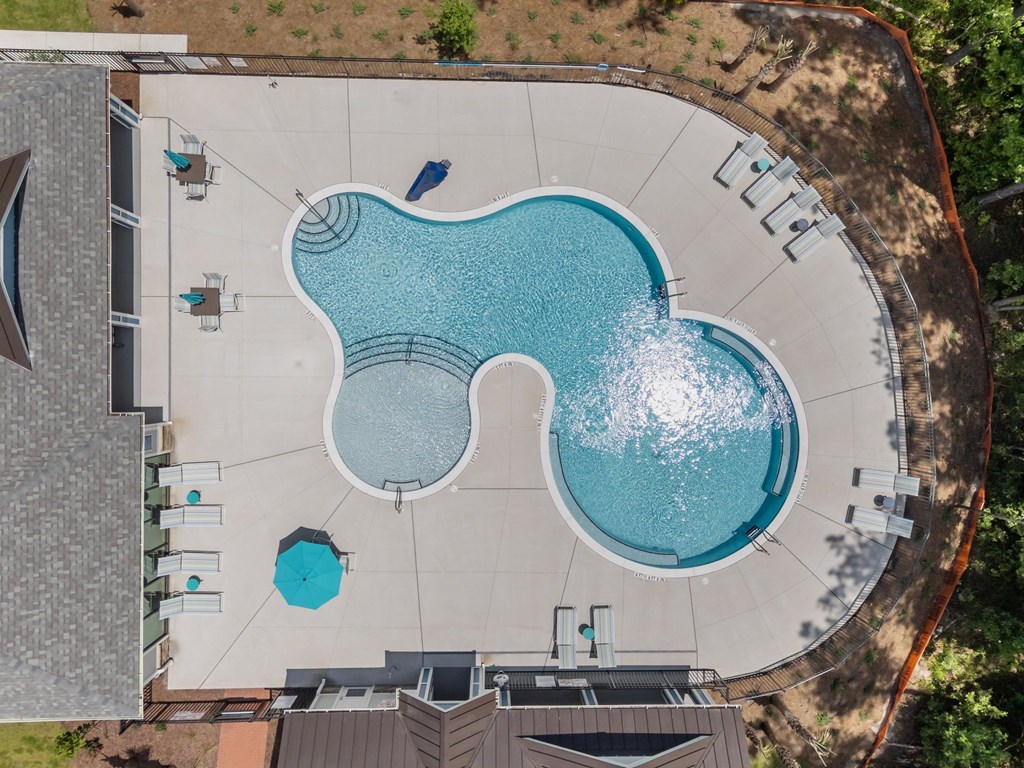 A large swimming pool with a small one in the middle.