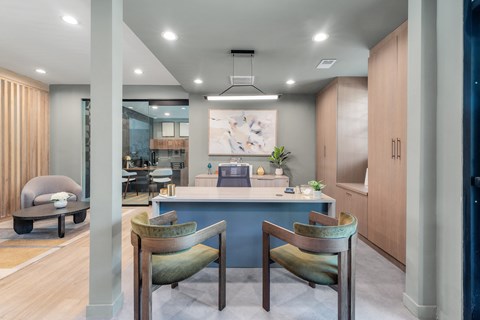 a dining room with a blue counter and chairs