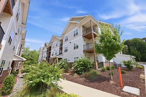 A view of apartment buildings with a clear blue sky above.