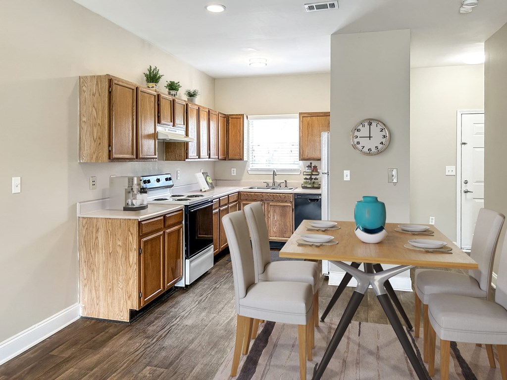 A kitchen with a table and chairs in the middle of it.