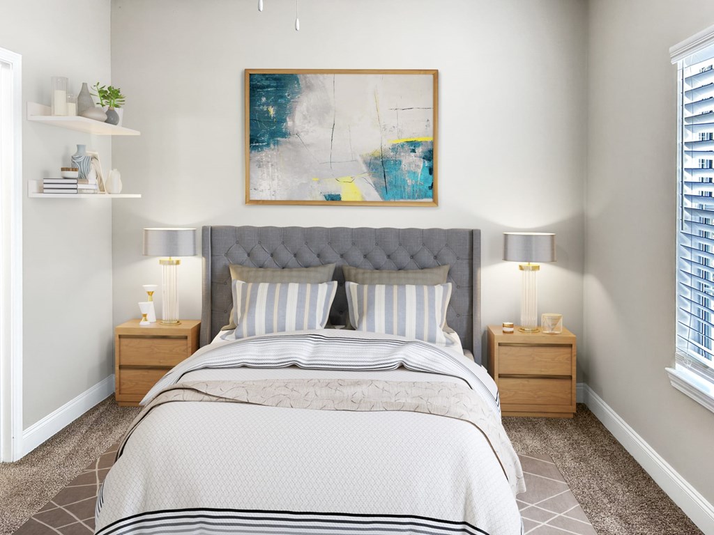 A bedroom with a large bed, two nightstands, and a painting on the wall.