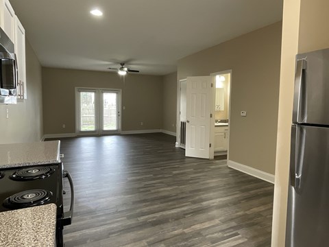 A kitchen with a stove top oven and a refrigerator.