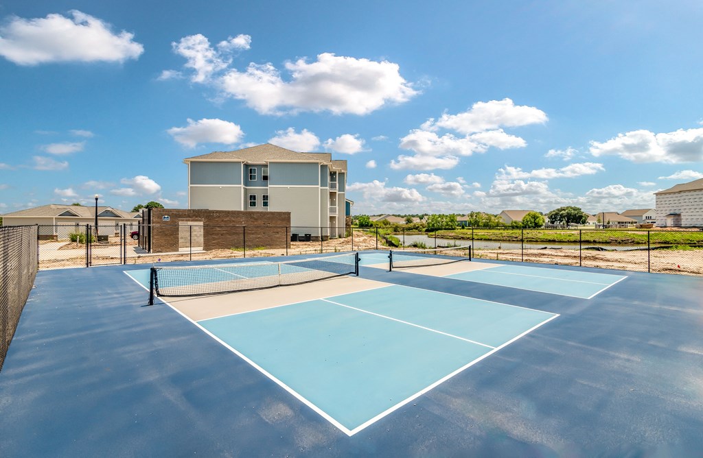 enjoy a game of tennis at the enclave at woodbridge apartments in sugar land, tx