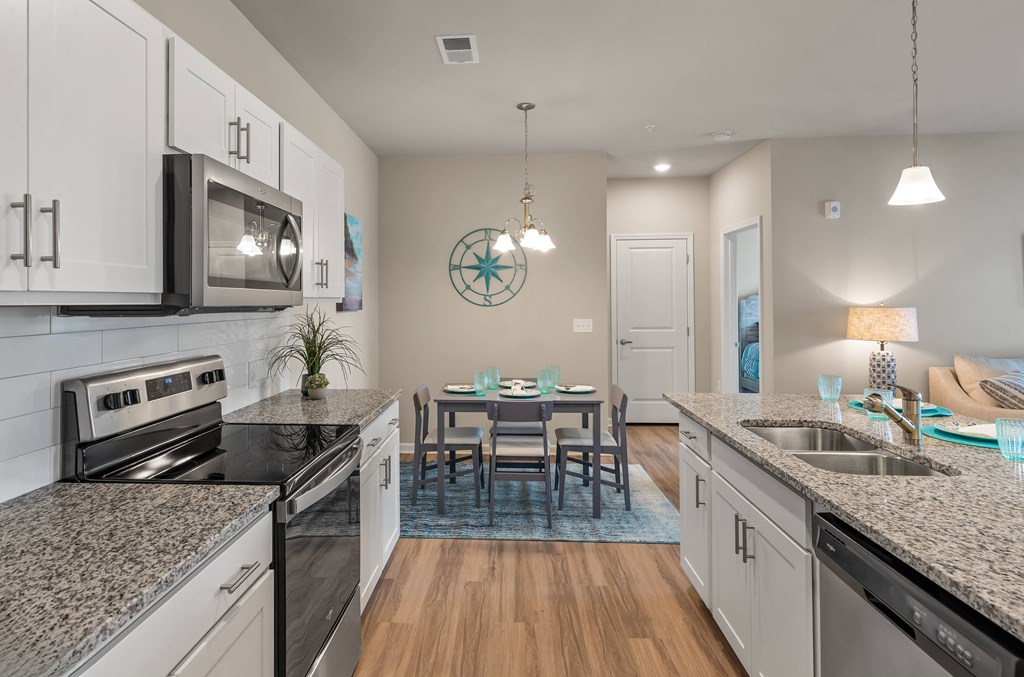 a kitchen and dining room with granite counter tops and stainless steel appliances