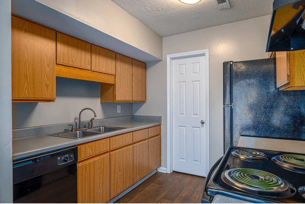 a kitchen with a stove sink and refrigerator