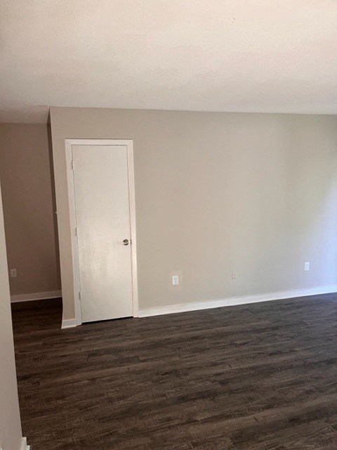 an empty living room with a white door