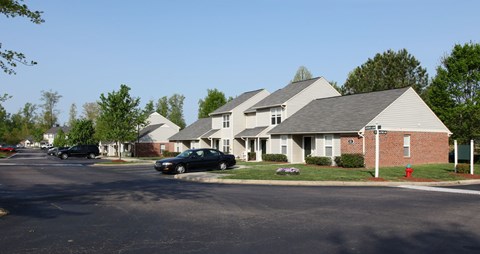 A black car is parked in front of a house.