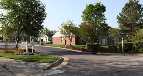 A residential street with houses and trees.