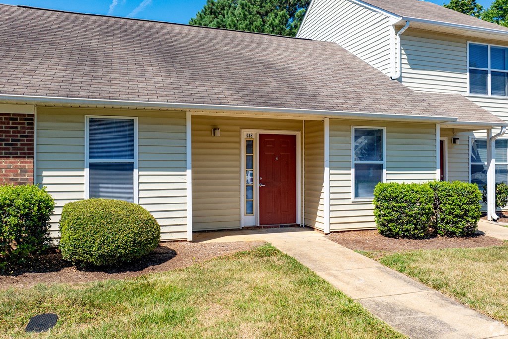 A house with a red door and two windows.