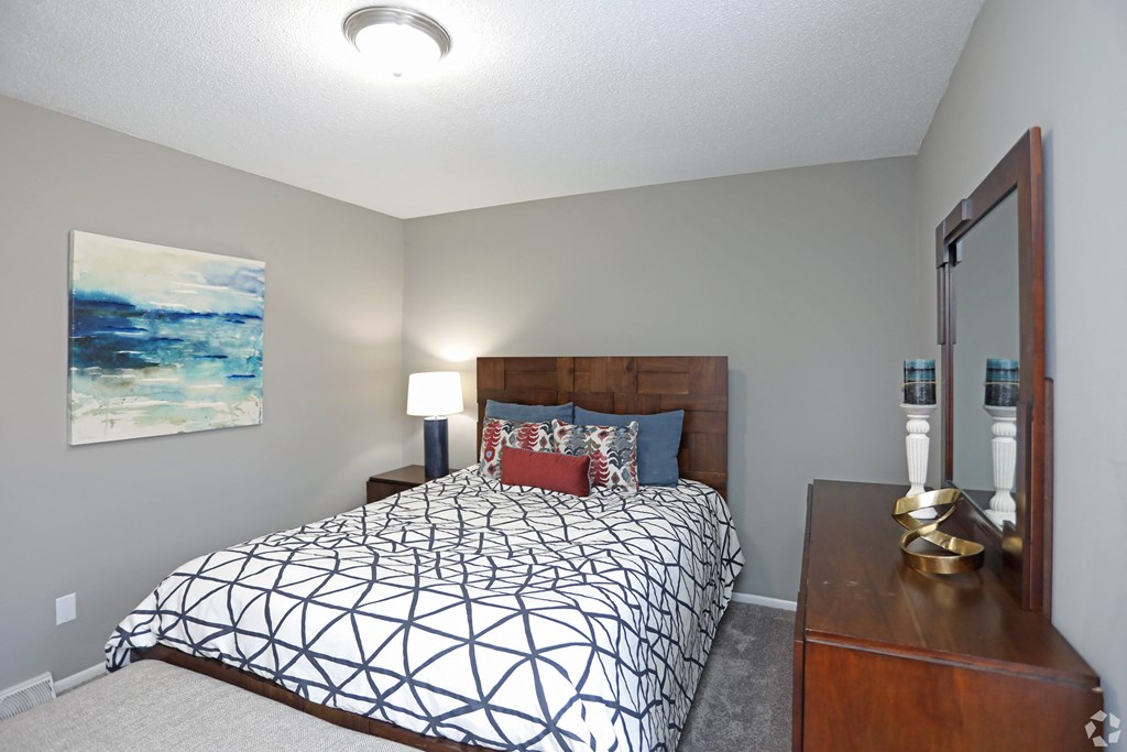 us census designated place bedroom with a large bed and a dresser