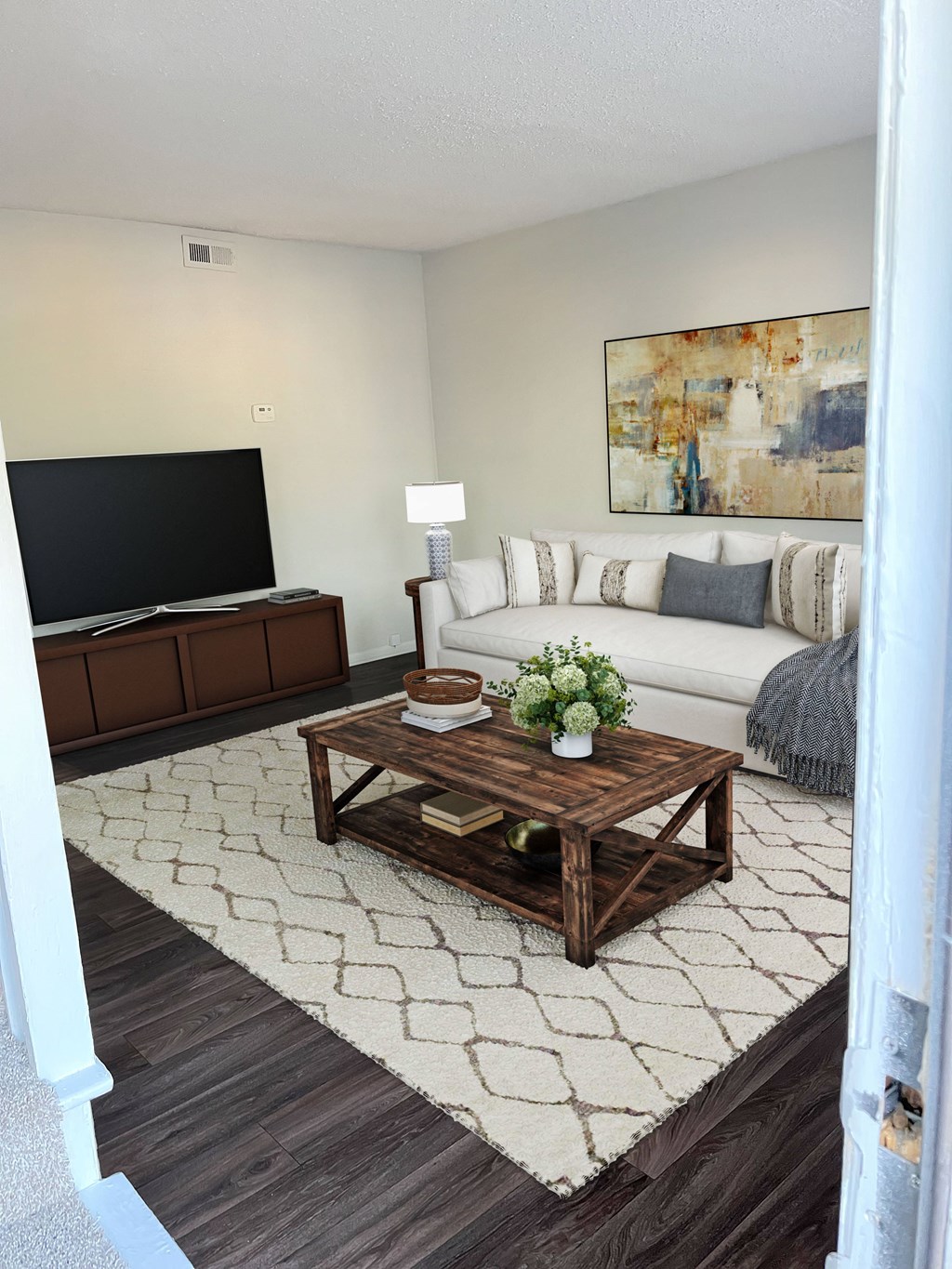 a living room with a white couch and a wooden coffee table