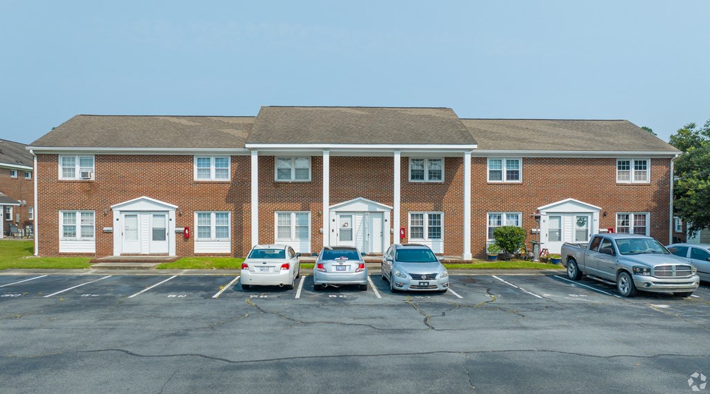 a large brick building with cars parked in front of it