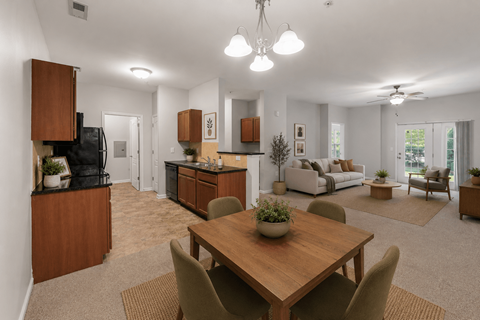 A well-lit, modern kitchen and dining area with a wooden table and chairs.