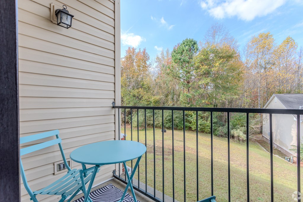 A balcony with a blue chair and table.