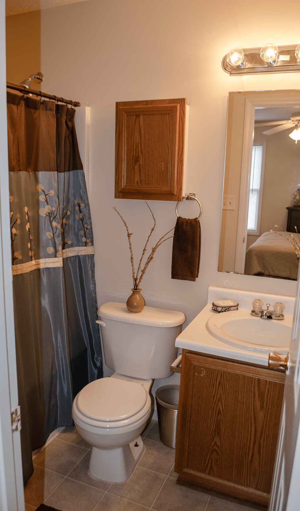 a bathroom with a shower curtain and a toilet and a sink
