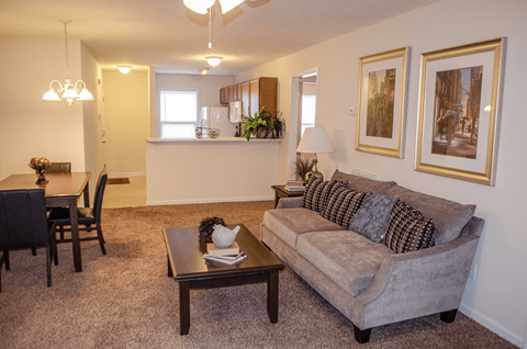 a living room and dining room with a couch and a table