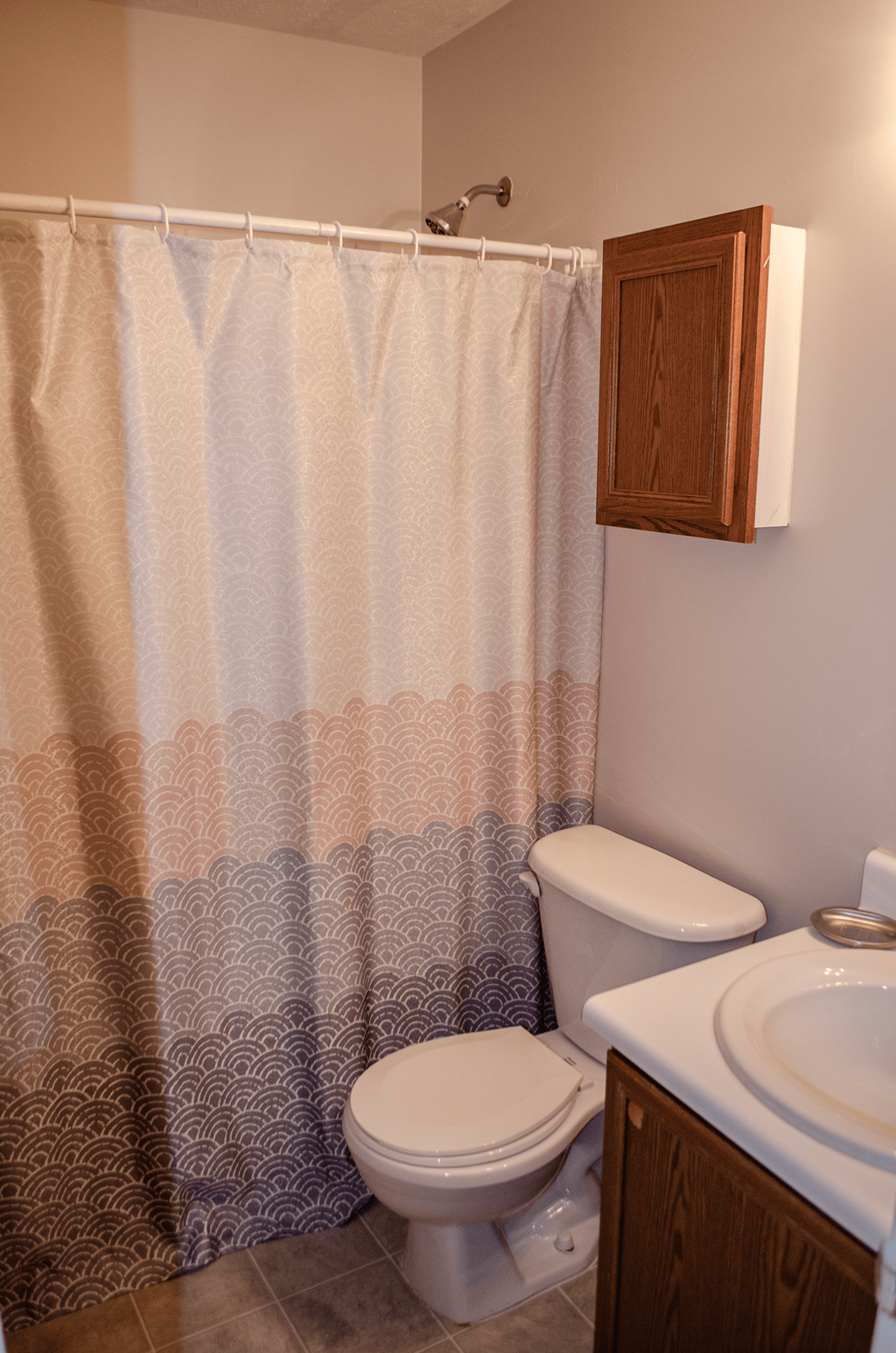 a bathroom with a toilet and a shower curtain