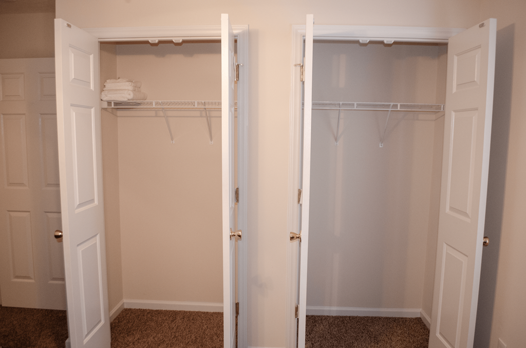 a closet with two doors and two closets in it
