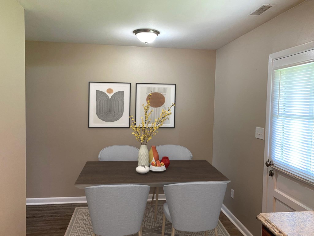 a dining room with a table and chairs